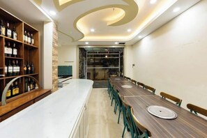 A long dining table with chairs, a wine rack, and a modern ceiling design. - Adalia Villa With ValeyView - O'TEL (Dalat)