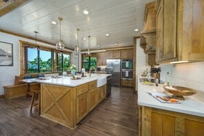 Una cocina amplia con armarios de madera, una isla grande y vistas al exterior.
