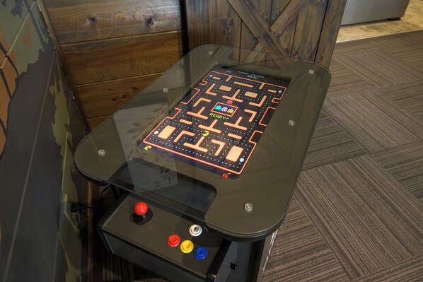 A table with a maze game on top, featuring a joystick and buttons.