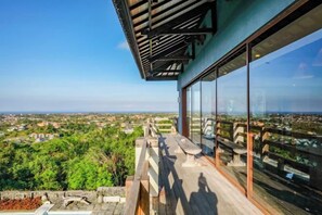 A modern building with large windows overlooking a green landscape. - The Lavana Villa Gajah Jimbaran (Bali)