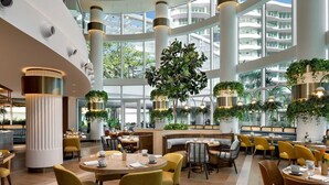 A spacious hotel lobby with high ceilings, large windows, and multiple seating areas. - Spacious Balcony Retreat Close to Fort Lauderdale Beach – Recharge in Modern Ele (Fort Lauderdale)