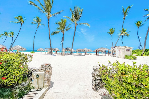 On the beach, white sand, sun loungers, beach umbrellas