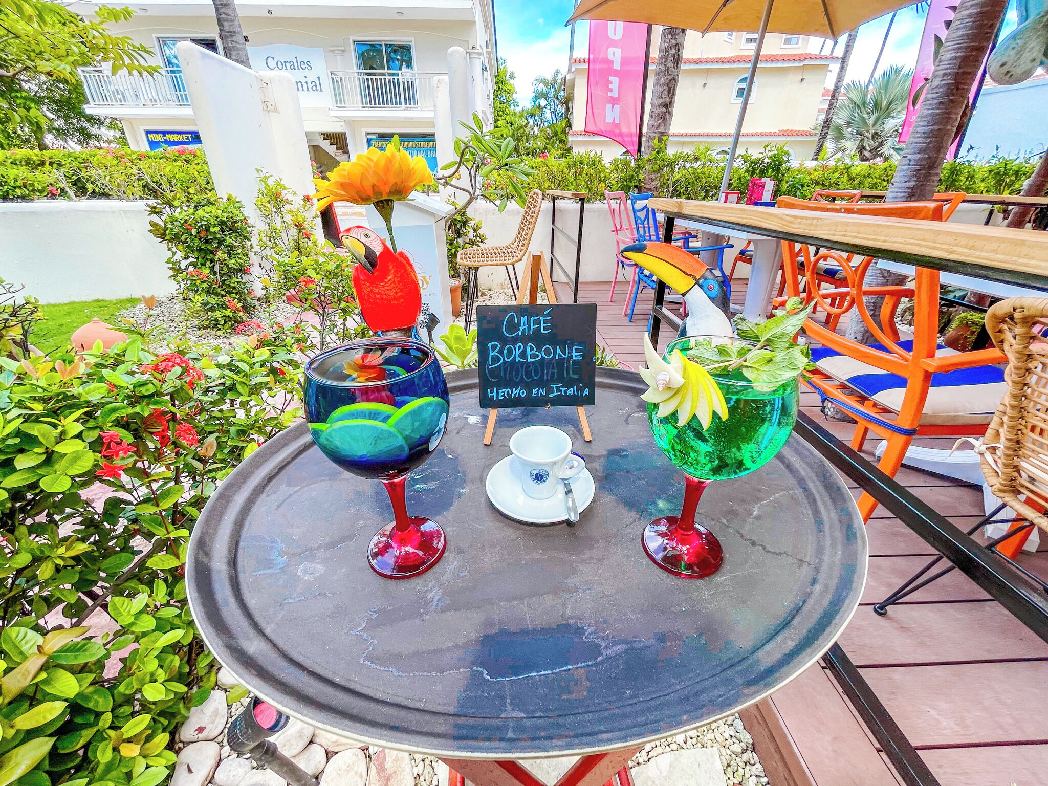 Une table avec deux boissons colorées et un panneau indiquant un café.