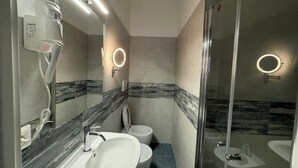 A modern bathroom with a large mirror, a hairdryer, a toilet, and a shower area. - Costantino Rooms (Rome)