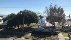 A gazebo with a metal roof, surrounded by trees and a clear sky. - Unit 222 Beautiful Cedar key (Cedar Key)