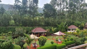 A lush garden with a gazebo, a covered seating area, and a small pavilion. - Famous Gates Hotel Bomet  (Bomet)
