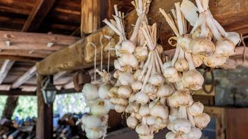 A rustic wooden structure with hanging bunches of onions.