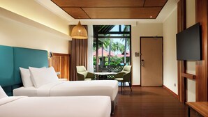 A hotel room with two beds, a TV, a wooden ceiling, and a view of the outdoors. - Hilton Garden Inn Kota Kinabalu Tuaran (Tuaran)