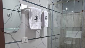 A modern bathroom with a glass shower enclosure, a marble backsplash, and a double sink vanity. - Hotel Rosa Mistica Inn (Arequipa)