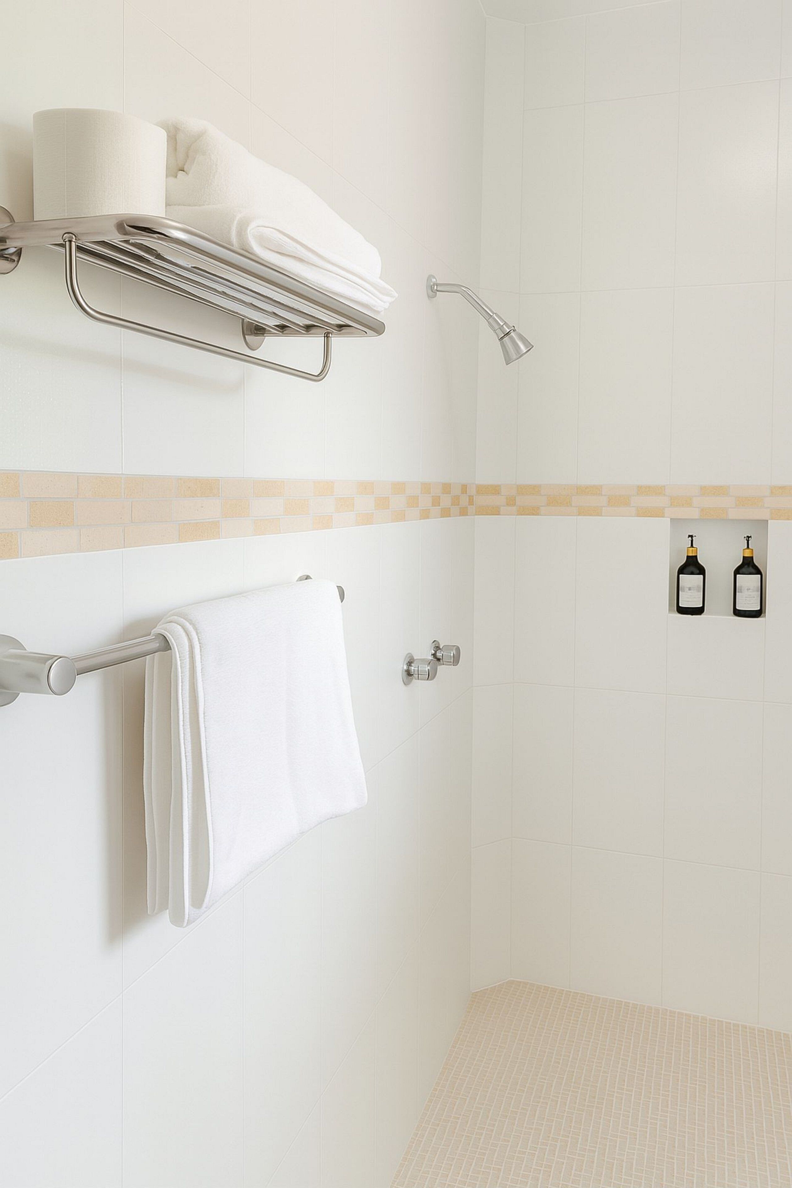 A bathroom with a shower, a towel rack, and two bottles of shampoo.
