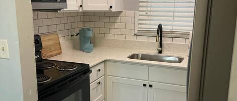 Fridge, microwave, stovetop, coffee/tea maker