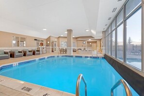 An indoor swimming pool with a clear view of the surrounding area, including a reception desk and seating area. - Drury Inn & Suites Colorado Springs (Colorado Springs)