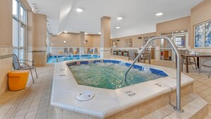Ein Hotelpoolbereich mit Whirlpool, Sitzgelegenheiten und einem Billardtisch.