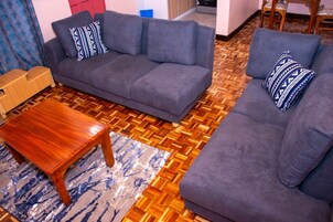 Deluxe Apartment | Living area | 32-inch Smart TV with digital channels