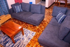 Deluxe Apartment | Living area | 32-inch Smart TV with digital channels
