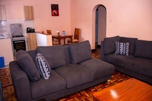 Deluxe Apartment | Living area | 32-inch Smart TV with digital channels