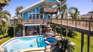 A two-story house with a balcony, a swimming pool, and a deck. - Margaritaville on the Bay by Ryson Vacation Rentals (Galveston)