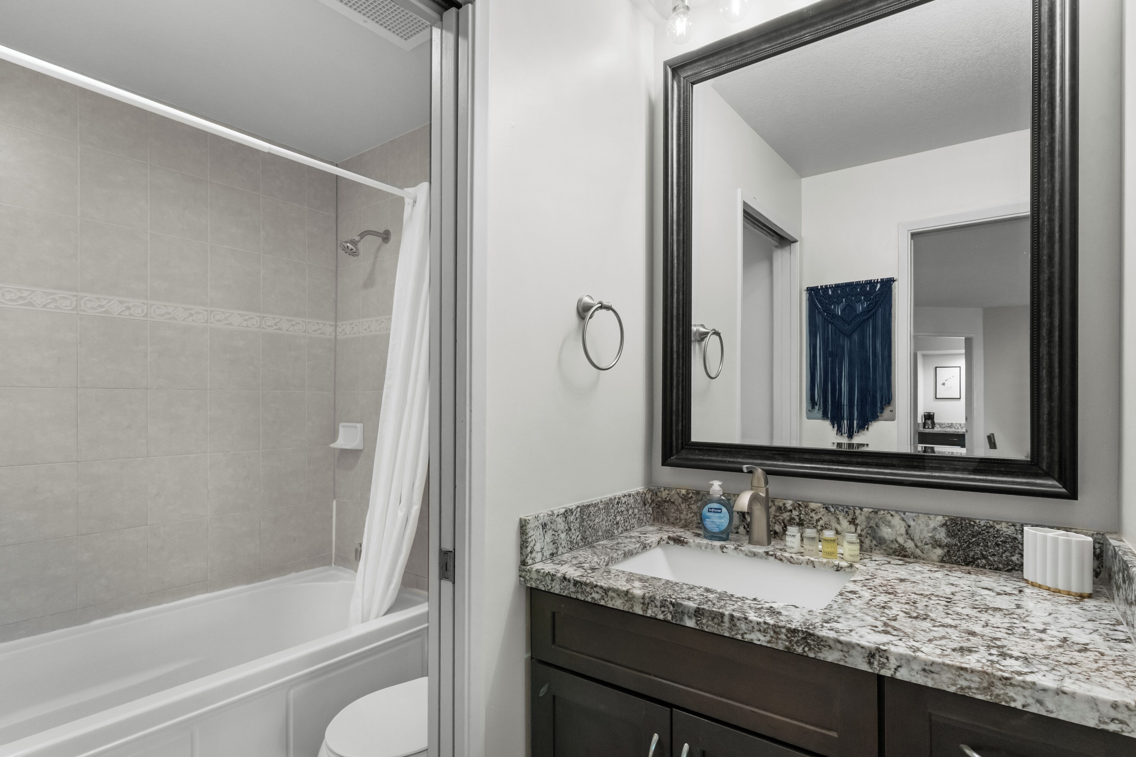 A bathroom with a shower, toilet, and sink.