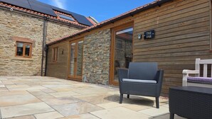 A stone building with a wooden exterior and a tiled roof. There is a sign that reads "THE OAK" on the wall. - The Oak, Country Home, Sleeps 4 with Hot Tub (Oakenshaw)