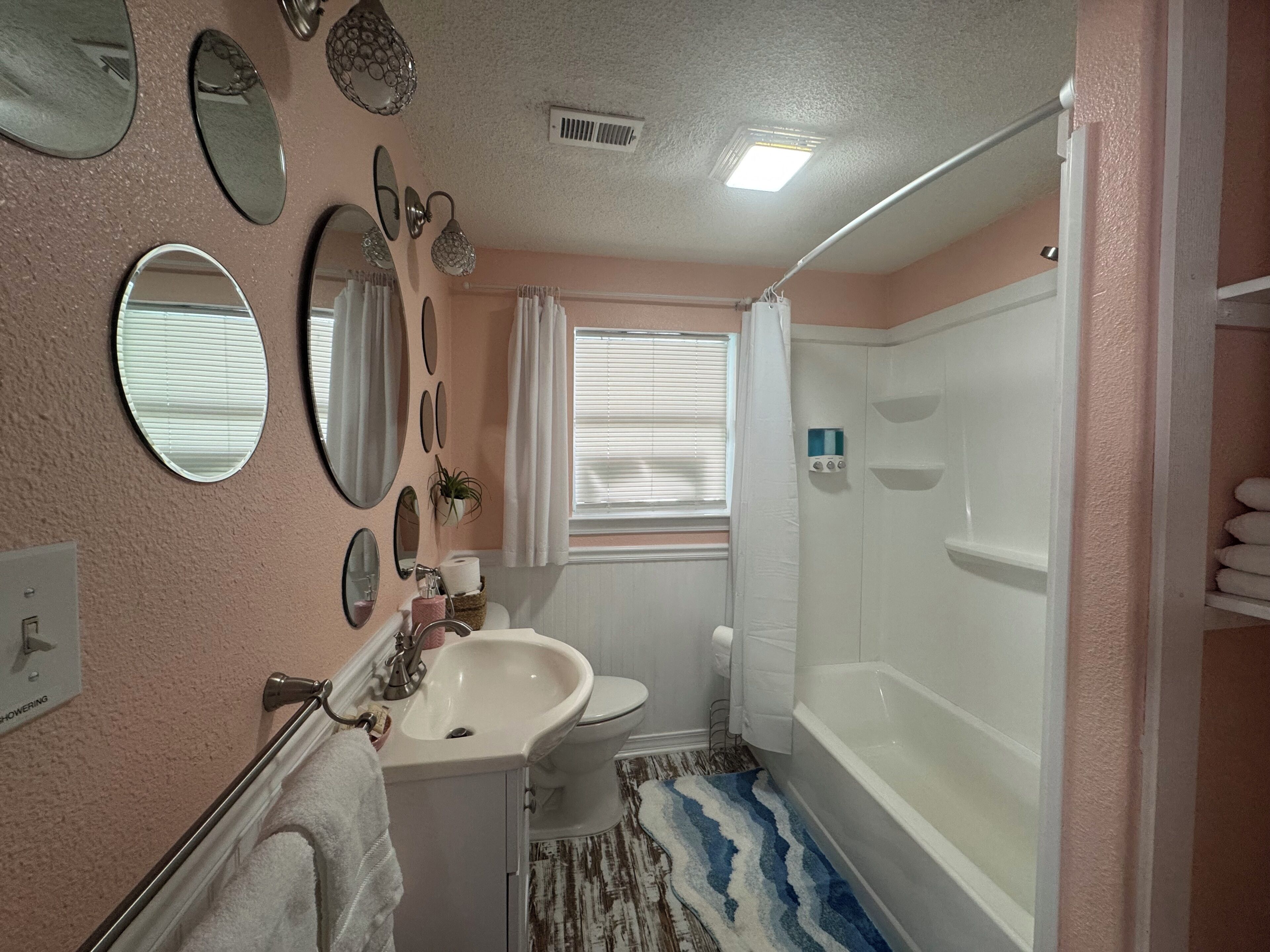 A bathroom with a sink, toilet, and bathtub.