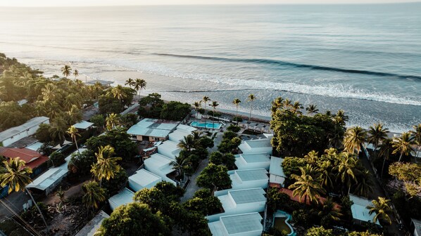 An aerial view of a resort with multiple buildings, a swimming pool, and a beach. - Beachfront Beach Break Villa @SurfCity (Conchalio)