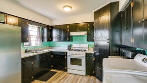 A compact kitchen with a stove, sink, and a microwave. - 2 Mi to Phillips 66 Refinery: Home w/ Yard (Borger)