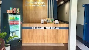 A reception desk with a wooden finish and a sign that reads "Villa Lakhang Thong". - Villa Lakangthong2 (Luang Prabang)