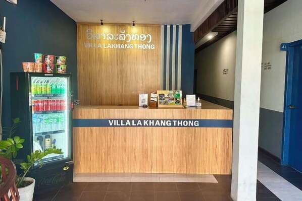 A reception desk with a sign reading 'Villa Lakhang Thong' and a beverage dispenser to the left. - Villa Lakangthong2 (Luang Prabang)
