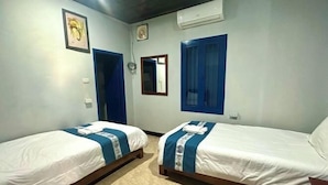A room with two single beds, a mirror, and a wall-mounted air conditioner. - Villa Lakangthong2 (Luang Prabang)