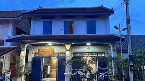 A two-story building with a sign indicating a restaurant on the ground floor. - Villa Lakangthong2 (Luang Prabang)