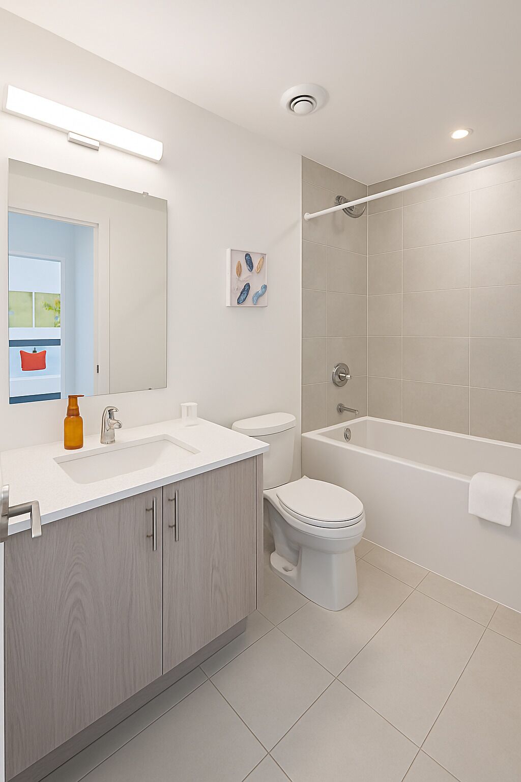 A modern bathroom with a sink, toilet, and bathtub.
