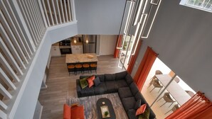 A modern interior with a living area, kitchen, and dining space.