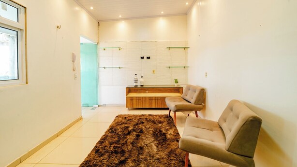 A modern living room with a sofa, a coffee table, and a rug.