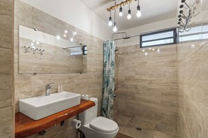 Bungalow, Multiple Beds, Oceanfront | Bathroom | Shower, towels, soap, shampoo