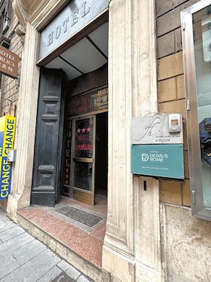 A hotel entrance with a sign reading "HOTEL DOMUS ROME" and a "CHANGE ROOM" sign. - Hotel Domus Rome (Rome)