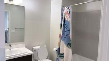 Deluxe Apartment, Garden View | Bathroom | Hair dryer, slippers, towels, soap