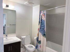 Deluxe Apartment, Garden View | Bathroom | Hair dryer, slippers, towels, soap