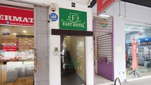 A hotel entrance with a sign reading "FAST HOTEL" and a visible phone number. - Fast Hotel Sri Gombak By Zuzu (Batu Caves)