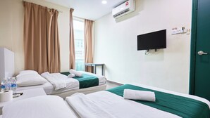 A hotel room with two beds, a TV, an air conditioner, and a window with curtains. - Fast Hotel Sri Gombak By Zuzu (Batu Caves)