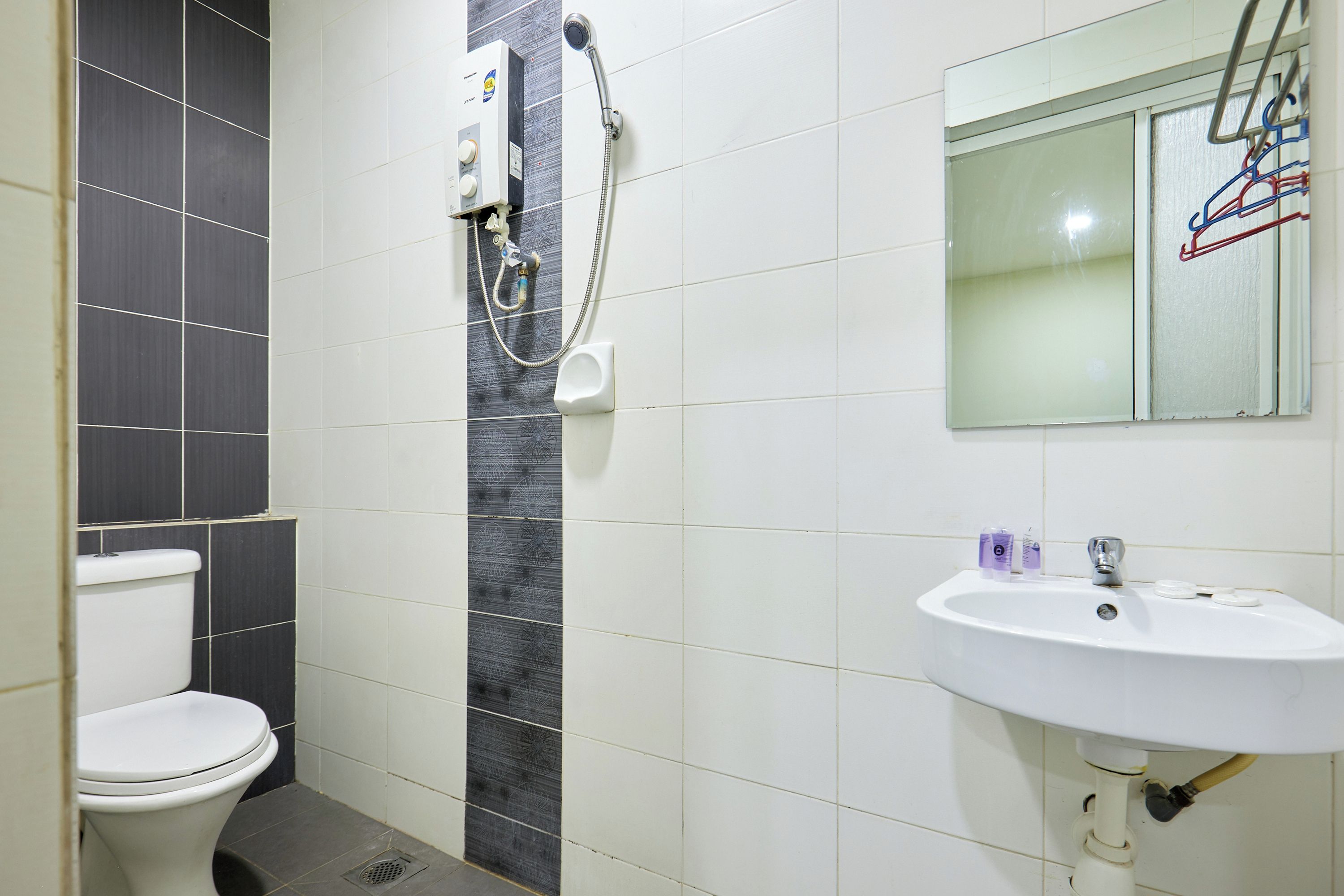A bathroom with a toilet, a sink, and a shower.