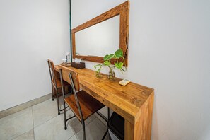 A wooden desk with a mirror, a chair, a plant, and a tissue box. - Omah Gerjen 29 By Zuzu (Yogyakarta)