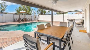 A covered outdoor area with a pool, seating, and a ceiling fan. - *NEW* Western Desert Pool Oasis! Fire Pit & Grill! (Glendale)