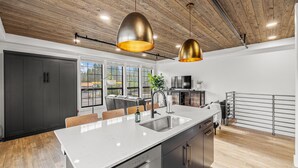 A modern kitchen with a large island, stainless steel appliances, and pendant lighting. - The Loft 7- Steps from the Lake & Dining- Newly renovated in the heart of McCall (McCall)