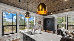 A modern kitchen with a large island, a built-in sink, and pendant lighting. - The Loft 7- Steps from the Lake & Dining- Newly renovated in the heart of McCall (McCall)
