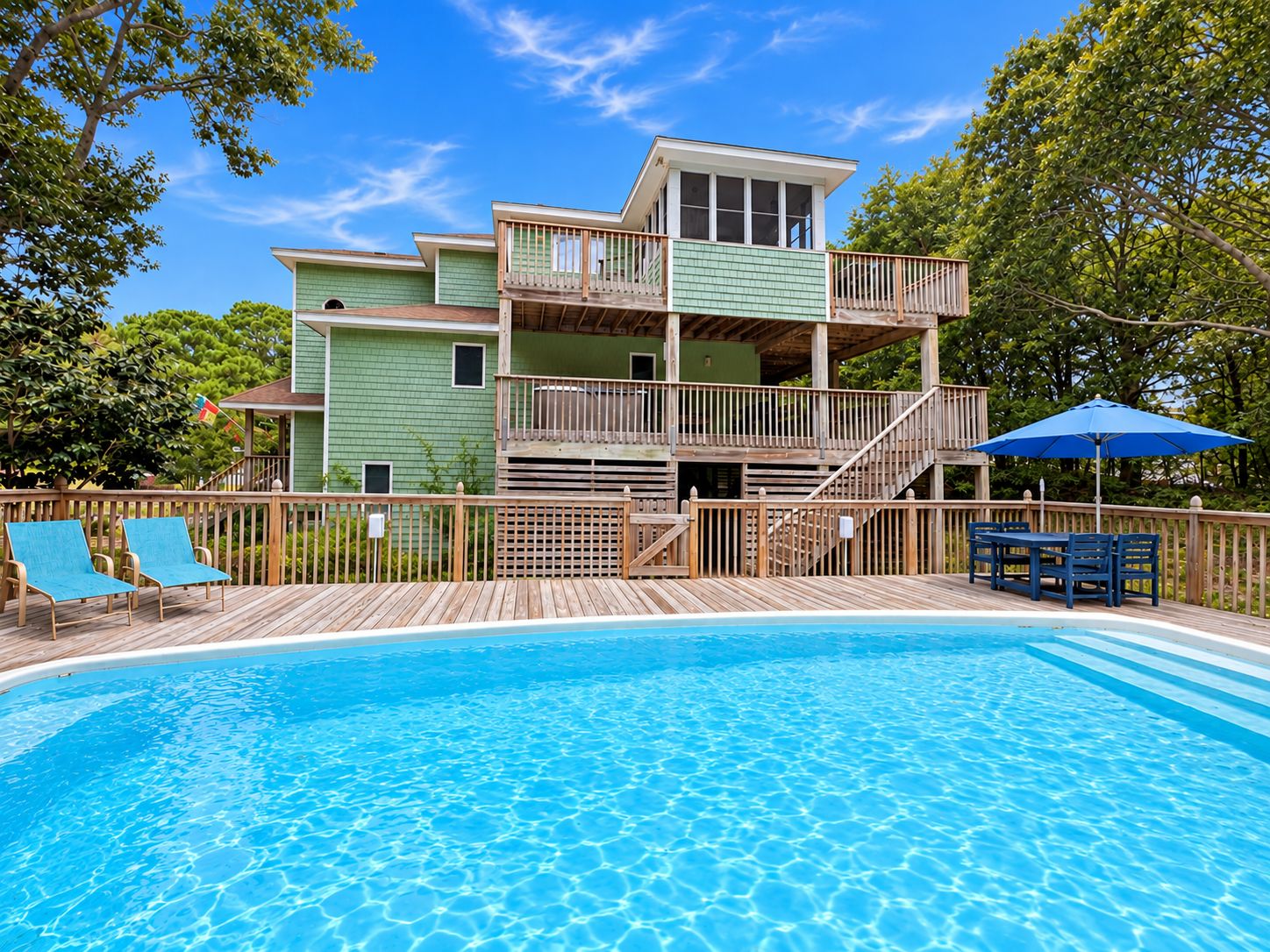 A two-story building with a pool in front.