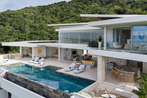A modern multi-level house with a large outdoor pool, multiple seating areas, and a bar. - Bow Villa by Sublime Samui Villas (Koh Samui)