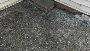 A white door with a metal handle and a small concrete step leading to a gravel driveway. - Cozy Suburb Studio (Everett)