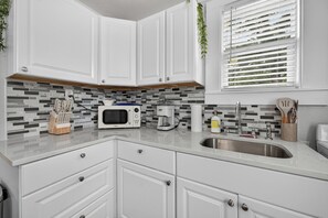 Fridge, microwave, stovetop, coffee/tea maker