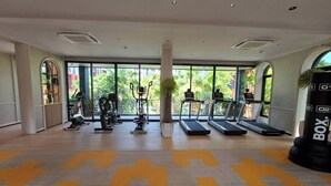 Ein Fitnessstudio mit Laufbändern, Crosstrainern und einem Schlagring.
