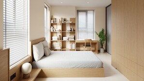 A modern bedroom with a large bed, a desk, and a bookshelf. - Bcons City Hotel (Ho Chi Minh City)